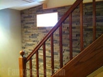 Stone veneer wall panels added to a finished basement
