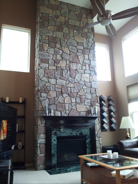 Fireplace transformed with faux Fieldstone panels installed by a DIY homeowner in her Michigan home's family room.