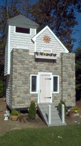 A father builds a fairy tale castle playhouse for his daughter using decorative stone panels.