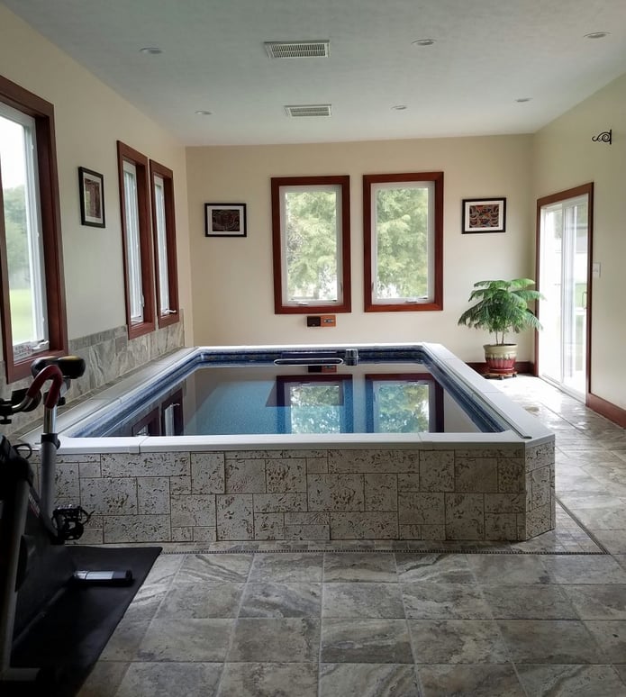 Pool surround idea: a home's small indoor pool covered in Bleached Coral Stone panels.