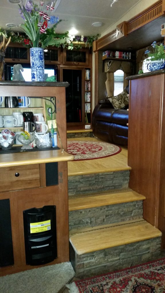 RV interior makeover with new bamboo flooring and faux drystack stone panels on the stairs.