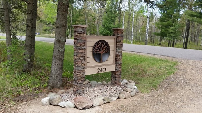 Exterior office sign built by GLS Precision Marketing using faux stacked stone columns.