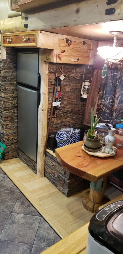 An RV's interior design with a rustic hunting lodge theme using Dry Stack stone panels.