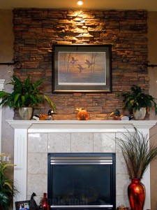 Adding a dash of sophistication to an already great looking fireplace. With the addition of a faux stone accent above the fireplace, these customers completely changed the ambience of their room.