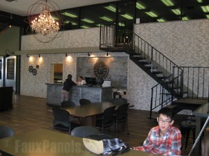 Updating the expansive wall to include faux brick panels created a clean, sophisticated touch to the overall design.