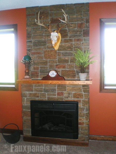 Fireplace and wall covered in Ledgestone style panels in Harvest color.