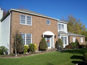 Stacked stone veneer exterior siding was installed to update this home's look on a budget.