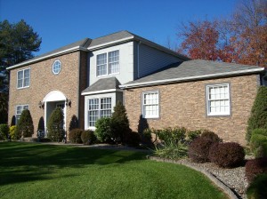 Stacked stone veneer installed This home's stucco exterior was transformed with stacked stone veneer panels.