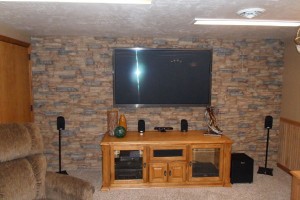Basement Design Accent Wall Basement converted into a man cave, complete with a stacked stone accent wall.