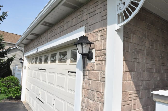 Close up view of Random Rock panels installed on a home garage's exterior.