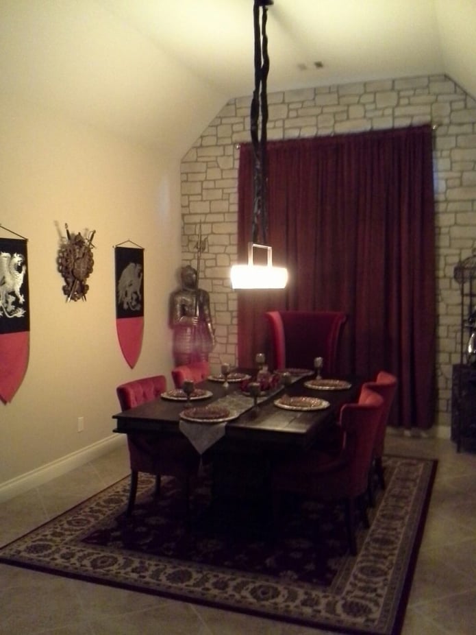 Medieval accessories like a red velvet drape and shields in the dining room helped complete the look.