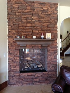 Fake stone veneer panels clad this fireplace for an amazing new look. Fireplace remodel using realistic, lightweight faux stone veneer panels.