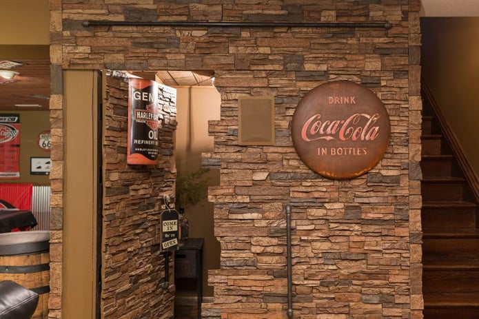 Secret room revealed - a hidden bathroom in the wall of this home's basement bar.