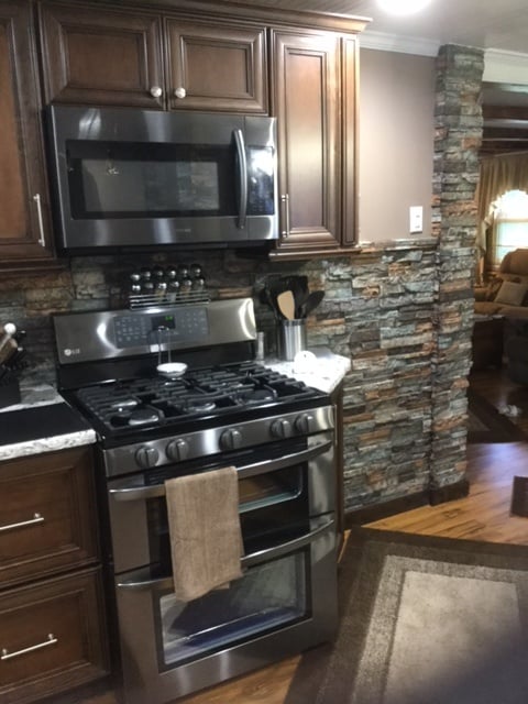 Waterproof, stone style panels installed as a kitchen backsplash.