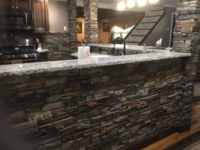 Drystack stone style kitchen wall coverings, breakfast bar and columns in a remodeled kitchen.