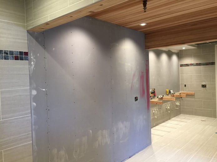 Before photo: sauna wall ready to be covered with waterproof paneling.