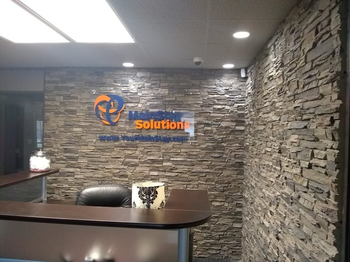 Office makeover using Norwich Stacked Stone panels on the walls of the reception area.