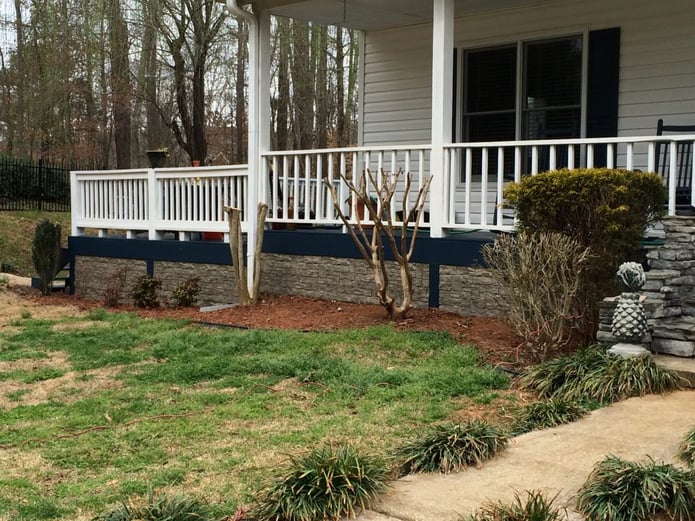 Close-up view of decorative stone skirting installed on a home's exterior