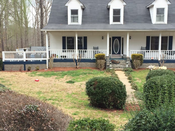 Home exterior remodeled with decorative stonewall panels used to create beautiful skirting.