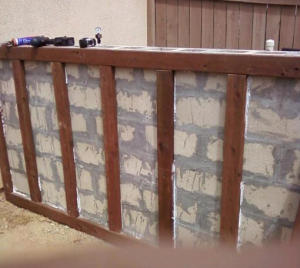 Wooden framework for faux stone siding Faux stone siding easily installs over this wooden framework