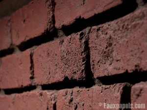 Extreme close up view of faux brick facing, simulating the look of real brick to an amazing degree.