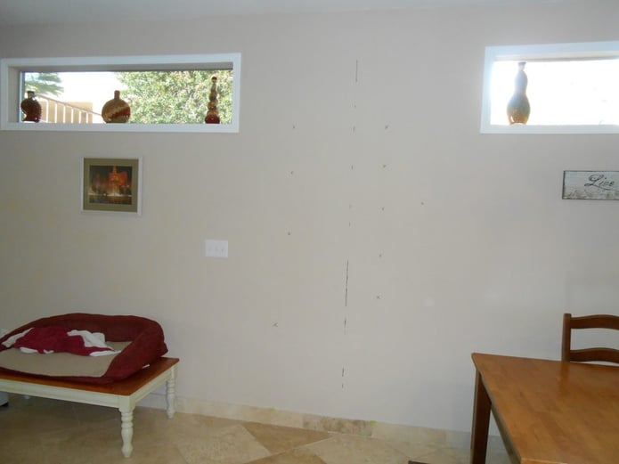 Before photo: reoccurring wall crack in a living room.