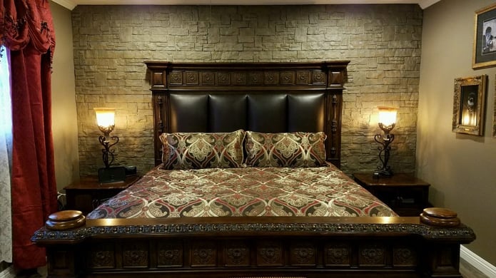 Romantic bedroom remodel with new stone-style focal wall.