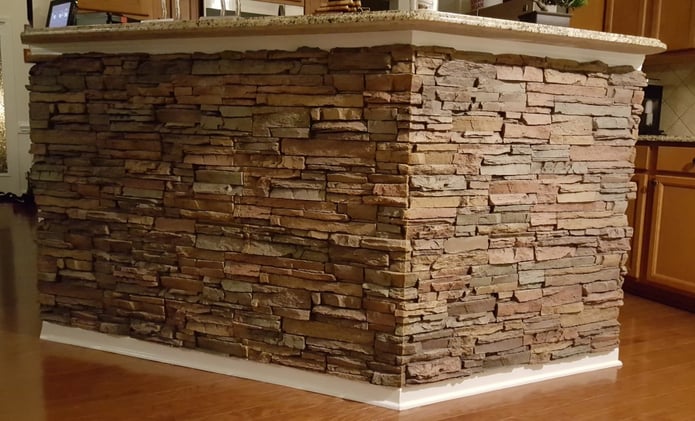 Kitchen counter makeover with stacked stone panels added to the counter wall