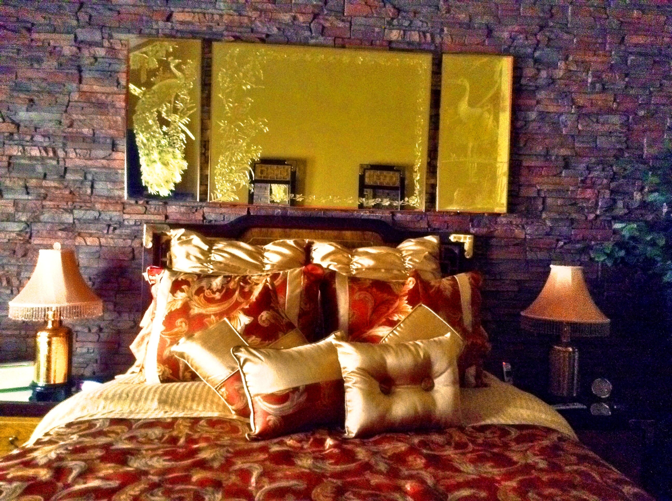Stacked stone wall panels make this bedroom look stunning.