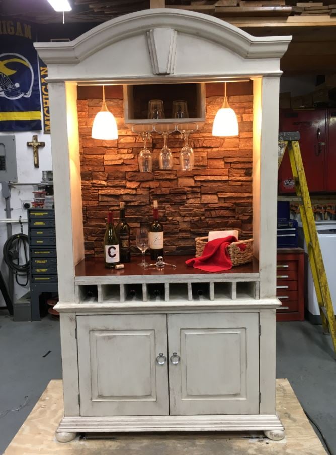 Art deco style bar cabinet finished with Norwich Stacked Stone panels in Sierra Brown