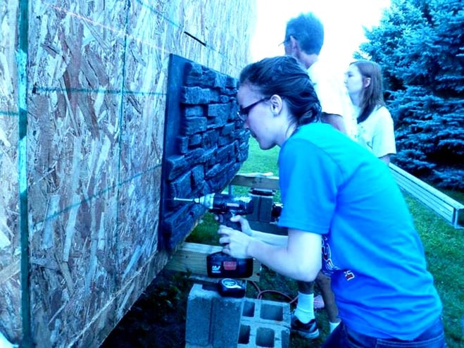 Kids help build the Enchanted Castle Playhouse for the Make-a-Wish Foundation.