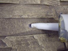 Panel hole repair is easy and cheap with just a little colored caulk.