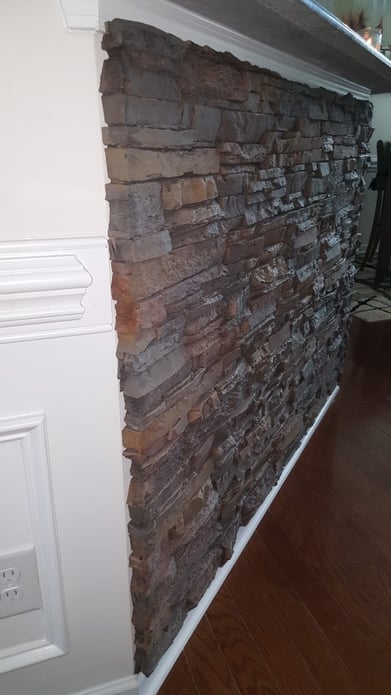 It looks like the stone is actually part of the wall itself.