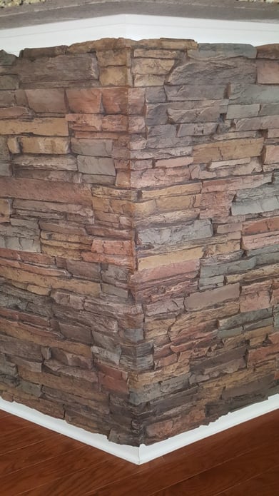 Close up view of mitered panels fitting snugly together on a kitchen counter's wall corner