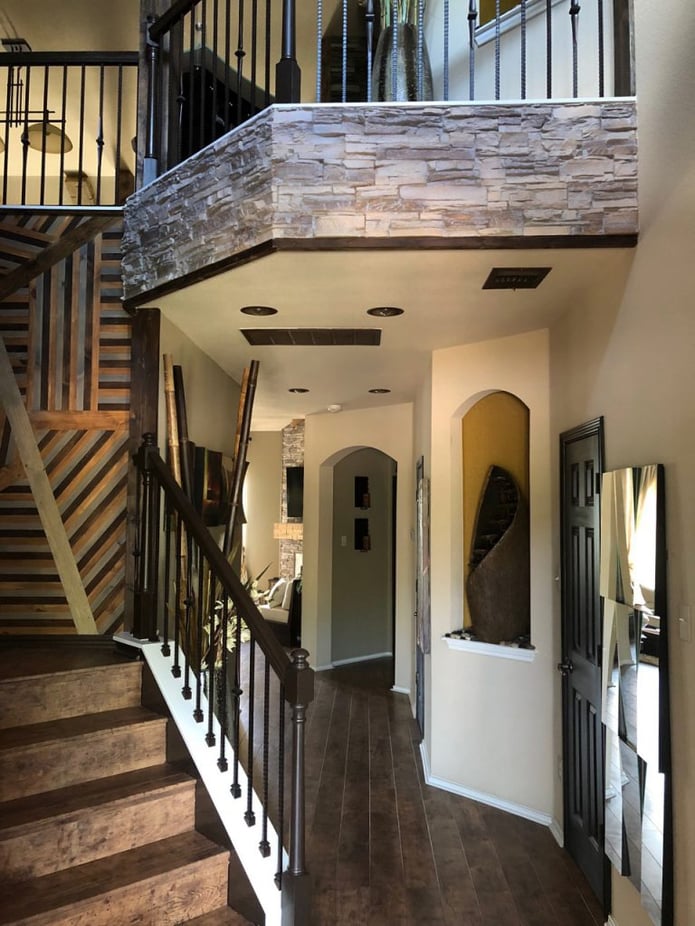 Mezzanine overhang accented with stacked stone paneling.