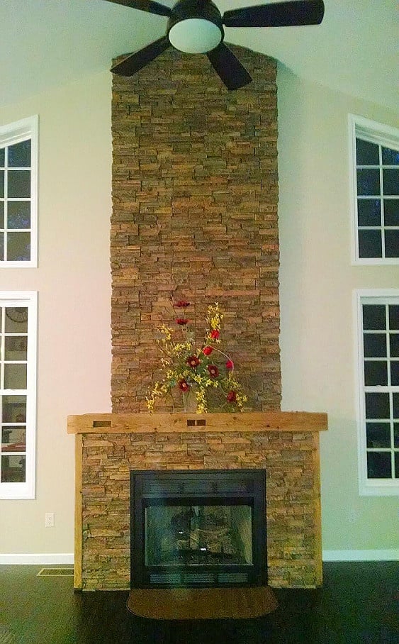 Fireplace built from scratch by a DIY husband and wife team, covered in Wellington Stacked Stone panels.
