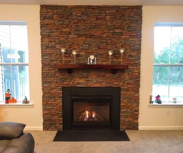 Fireplace wall design with stacked stone finish.