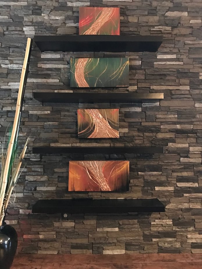 Closeup view of the floating shelves installed over the panels.