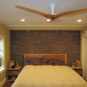 Synthetic stone makes for a dazzling accent wall behind the bed. Brian's bedroom design looks fantastic with our Norwich Stacked Stone Panels.
