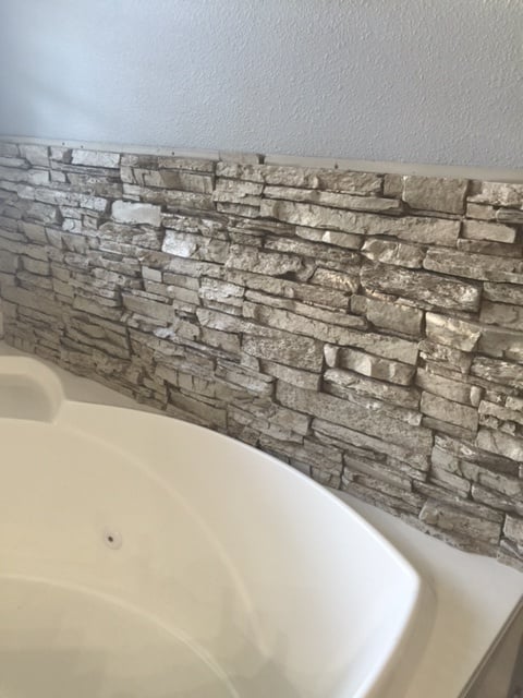 The panels installed directly onto the bathroom drywall with construction adhesive