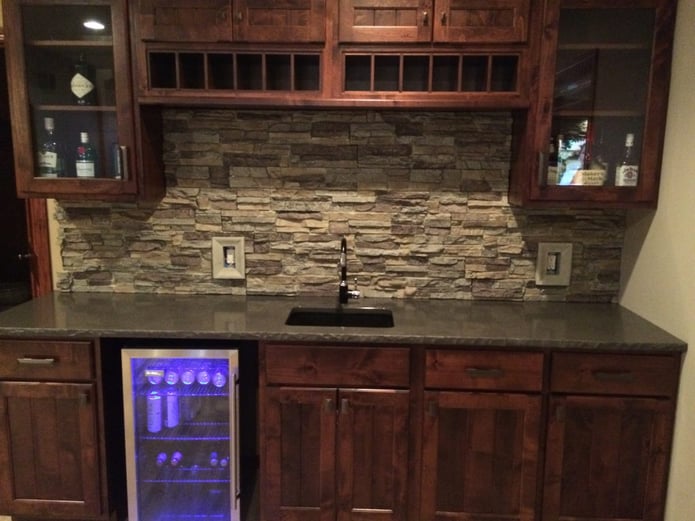 Man cave bar with new backsplash created with Regency Stacked Stone panels and matching outlet covers.