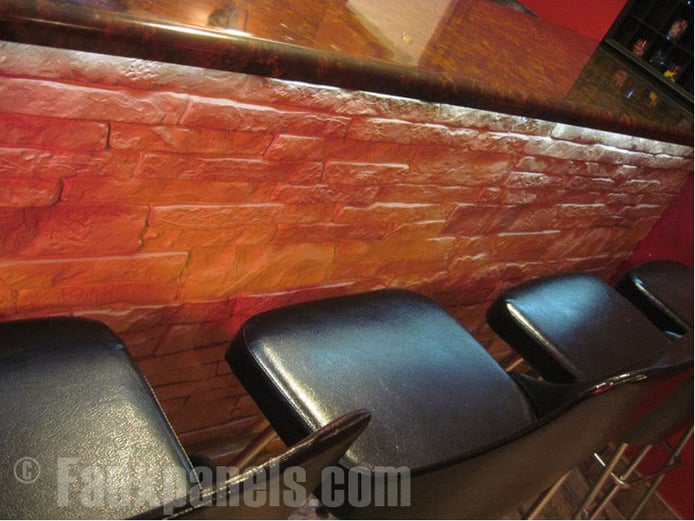 Close-up view of Nailon Stone Wall panels installed around a home bar