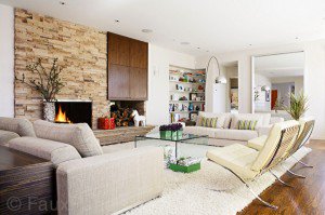 Living room accented with stone wall. Is it real or faux?