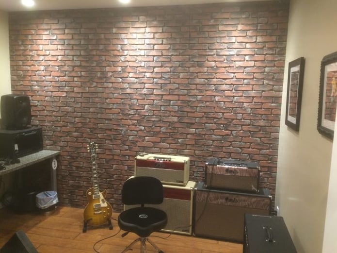 Tyler's music studio looks fantastic with a faux brick accent wall.