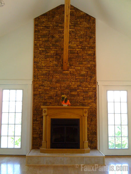 Home fireplace with a back wall covered in light tan stone wall veneer.