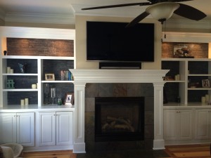 Barnwood faux wood panels provide a wonderful touch to these shelves.