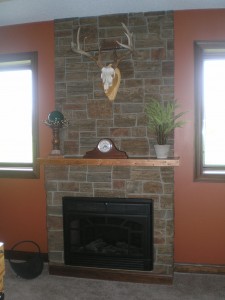 Basement bar fireplace surrounded with Carlton Ledgestone panels.