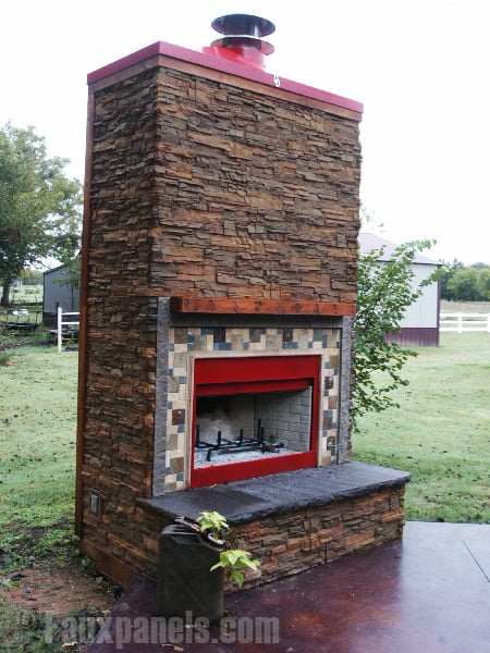 Outdoor fireplace covered with stacked stone veneer in earth tones