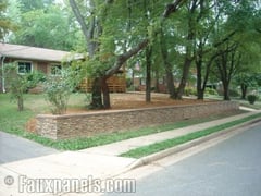 Faux stone and rock panels help give the illusion of expensive masonry by cladding an otherwise boring retaining wall.