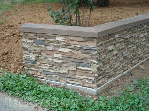 Beautiful retaining wall with a facade that mimics the look of real stacked stone.